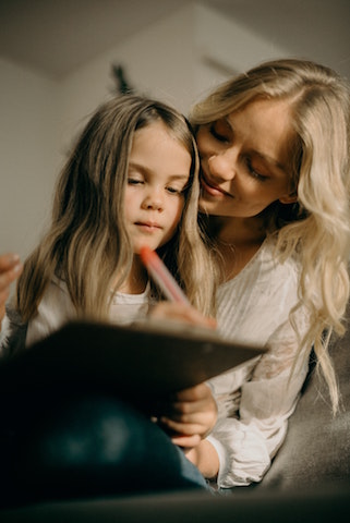 Girls writing on iPad